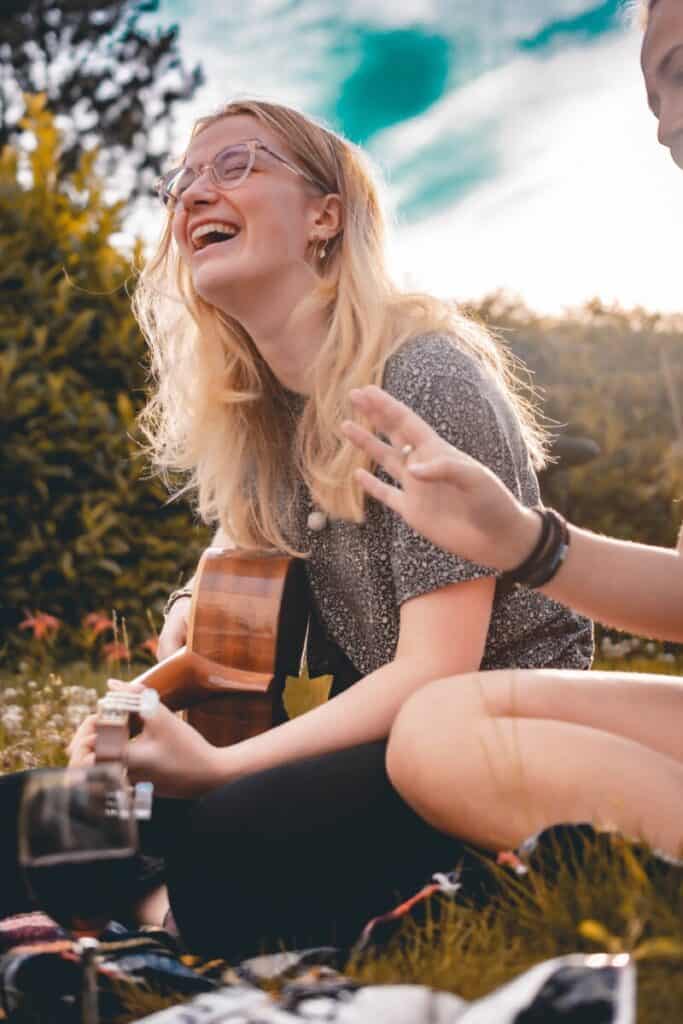 woman playing travel guitar