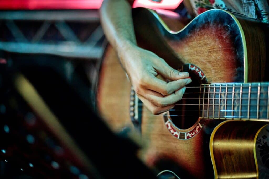 person practicing guitar