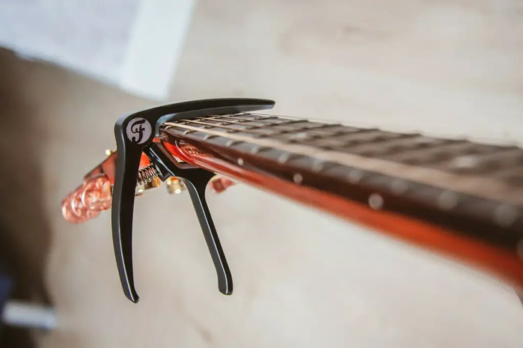 What is a capo on guitar use for?